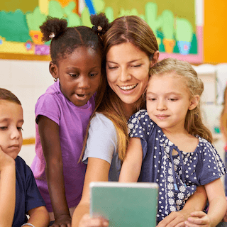 Teacher working with young children in classroom
